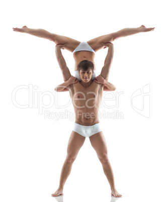Smiling muscular acrobat holds partner