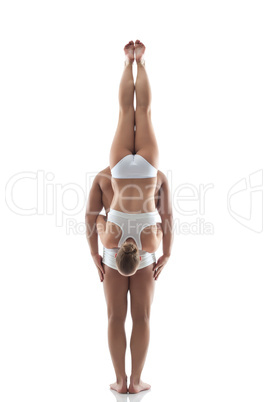 Image of acrobatic duo balancing in studio