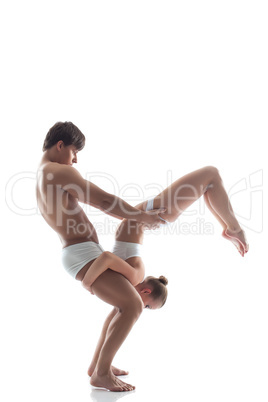 Duo of acrobats showing trick, isolated on white