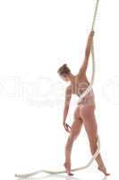 Slim naked model with rope posing back to camera