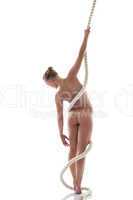 Graceful nude girl with rope posing back to camera