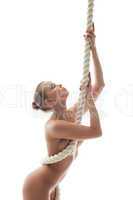 Portrait of beautiful nude woman posing with rope