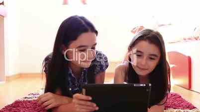 Teenage girls using tablet computer
