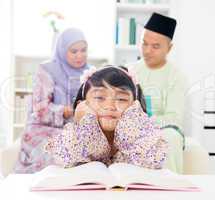 Malay girl reading book.