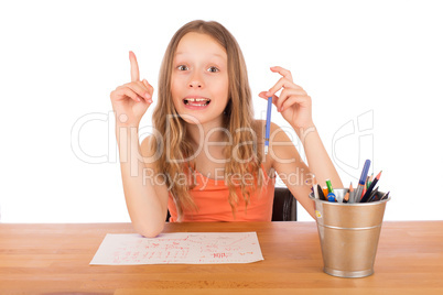 Child sitting at a table found an idea to draw