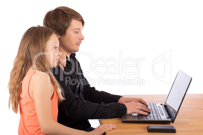 Father working with his daughter on a laptop