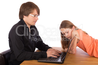 Daughter looks at her father's laptop