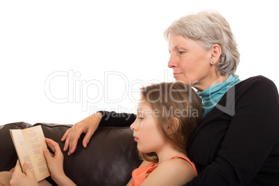 Grandmother read a book with her granddaughter