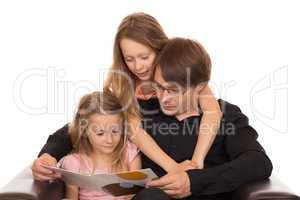Father read a book with his ??daughters