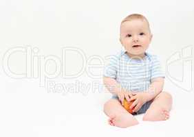 beautiful happy baby boy sitting on white bed with apple
