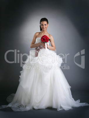 Young smiling woman posing in wedding dress