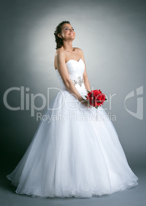 Beautiful slim bride posing in studio