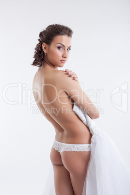 Seductive naked bride posing in studio