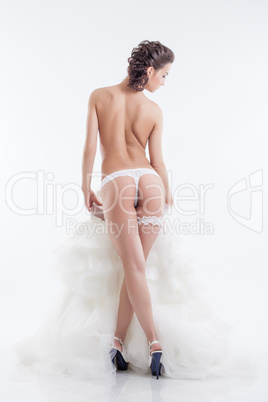 Naked slender bride posing back to camera