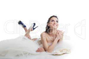 Smiling topless bride posing lying in studio