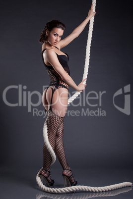 Hot model in erotic lingerie posing with rope