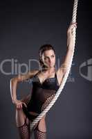 Portrait of sexy woman posing with rope