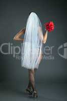 Slender model posing in veil and black stockings