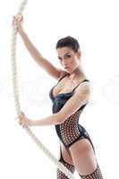 Portrait of hot brunette posing with rope