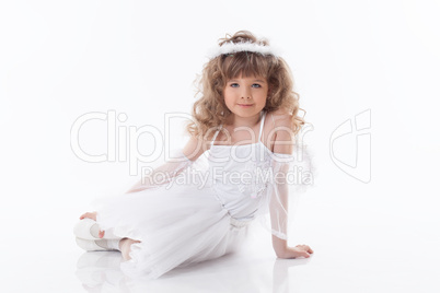 Smiling young girl posing in angel costume