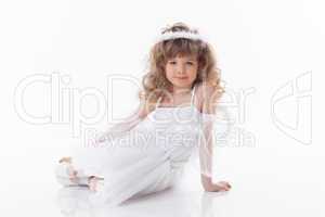 Smiling young girl posing in angel costume