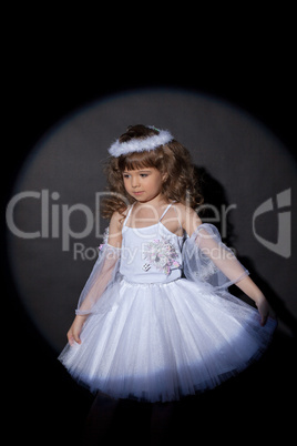 Portrait of adorable angel on dark background