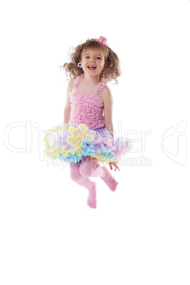 Adorable young girl posing jumping in studio