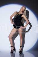 Sensual slim dancer posing in spotlight