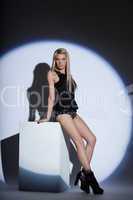 Image of beautiful slim blonde posing in spotlight