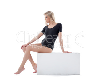 Sensual young blonde posing sitting on cube