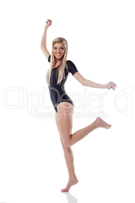 Young beautiful blonde posing jumping in studio
