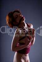 Hot red-haired woman bound naked with rope