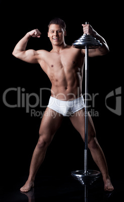 Handsome muscular sportsman posing with rod
