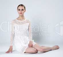 Sensual slim woman posing sitting in studio