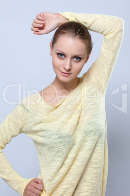 Portrait of pretty girl posing in yellow blouse