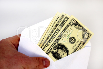 hand holding dollar banknotes in envelope