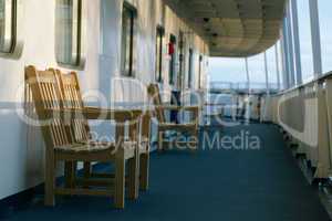 wooden chairs on the deck of cruise liner
