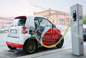 electro car is charging on the street.