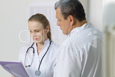 the nurse reported to doctor about medical tests.