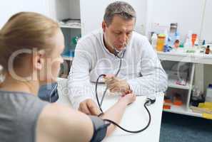 doctor measures the blood pressure