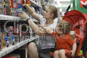 mother and son shopping for toys