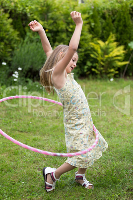 Little girl playing with hula hoop