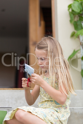 Little girl cutting paper
