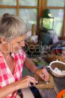 Senior woman cutting food