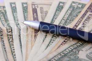 Dollars and pen