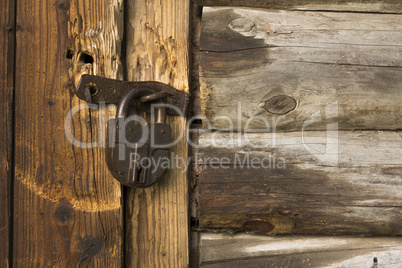 Old wooden door with rusty lock
