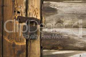 Old wooden door with rusty lock