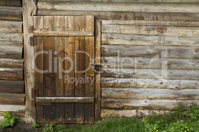 Old wooden wall and door with rusty lock