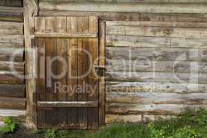 Old wooden wall and door with rusty lock