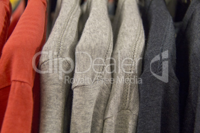 Colorful t-shirts on a shopping rack